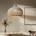 Handwoven rattan pendant light by DEMOLIGHTS hanging above a kitchen island, boho ceiling lamp with intricate woven design.