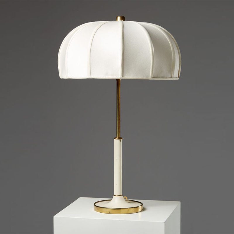 White mid-century modern DEMOLIGHTS table lamp with sleek design and cylindrical shade, ideal for stylish home lighting.