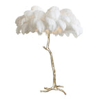 Luxury DEMOLIGHTS ostrich feather brass floor lamp with a tall, elegant design and feathered lampshade standing on a sleek base