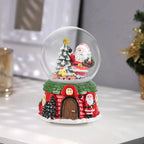 Garden Sanctuary Santa Claus snow ball gift music box Christmas glass ornament, featuring a festive Santa figure inside a snow globe.