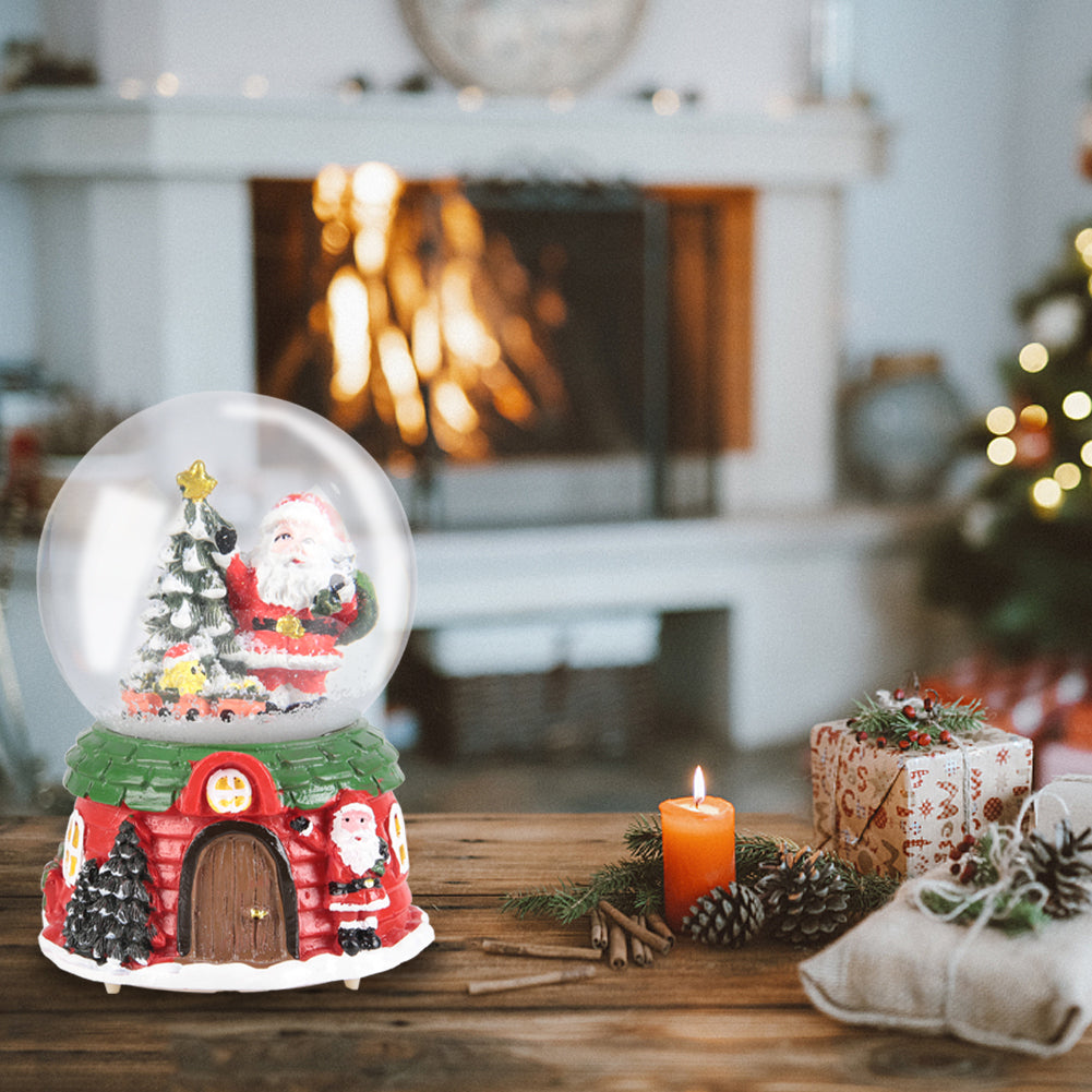 Garden Sanctuary Santa Claus snowball gift music box Christmas glass ornament with festive holiday design and intricate details.