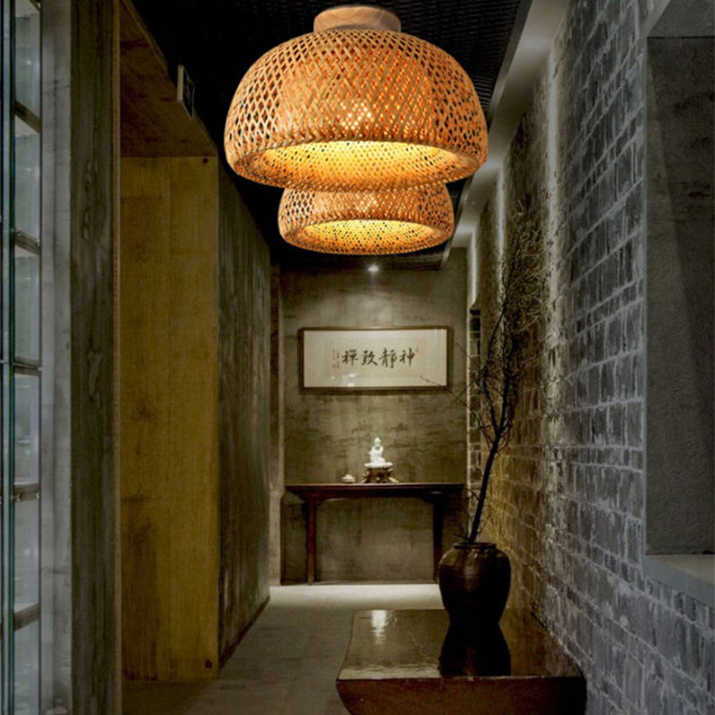 Handmade bamboo pendant light shade by DEMOLIGHTS hanging from ceiling, showcasing natural woven design and warm ambient lighting.