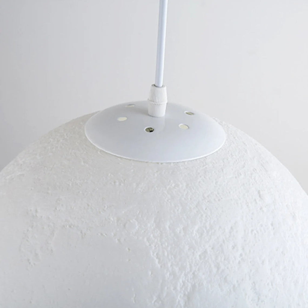 3D printed moon pendant light by DEMOLIGHTS hanging from ceiling, eco-friendly lunar globe chandelier for bedroom decor.