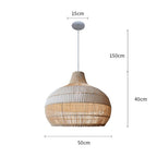 Handwoven rattan pendant light by DEMOLIGHTS hanging above a kitchen island, boho-style ceiling lamp with intricate woven design.