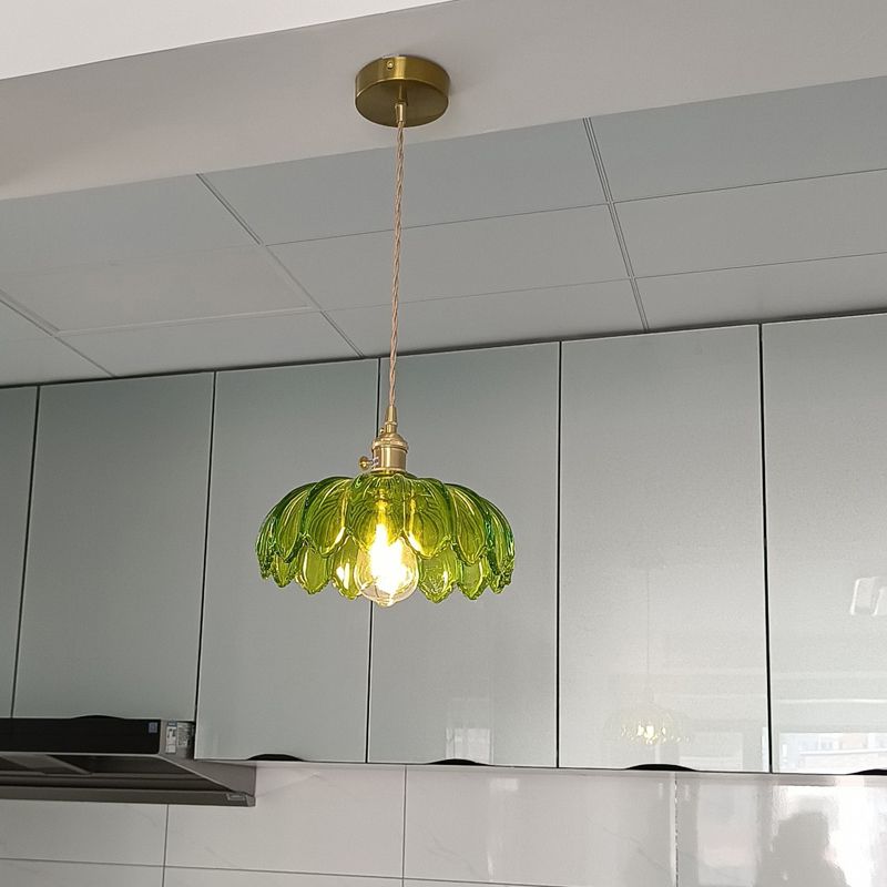 DEMOLIGHTS brass and glass dome pendant light hanging from ceiling, showcasing elegant modern design and clear glass shade.