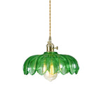 Demolights brass and glass dome pendant ceiling light fixture hanging from ceiling, modern lighting design with a clear glass dome.