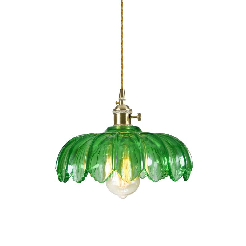 Demolights brass and glass dome pendant ceiling light fixture hanging from ceiling, modern lighting design with a clear glass dome.