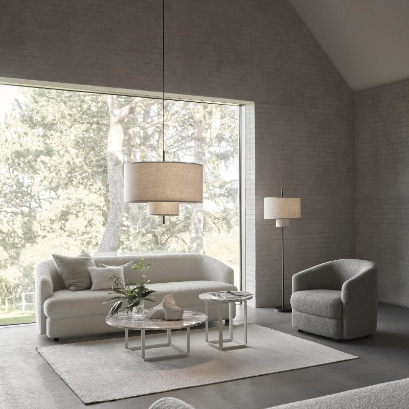 Modern fabric shade pendant light by Demolights featuring a sleek cylinder shape, hanging from a ceiling mount with warm light.