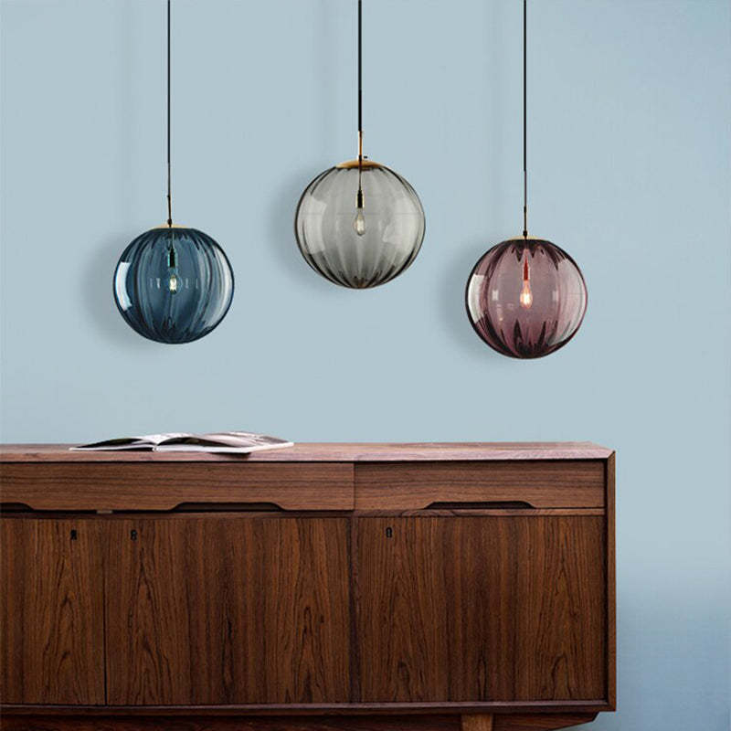 Clear glass ball pendant lamp by DEMOLIGHTS hanging from ceiling, showcasing modern pendant lighting design.