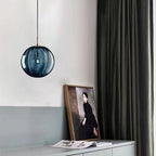Clear glass ball pendant lamp by DEMOLIGHTS hanging from ceiling, showcasing modern pendant light design and transparent glass shade.