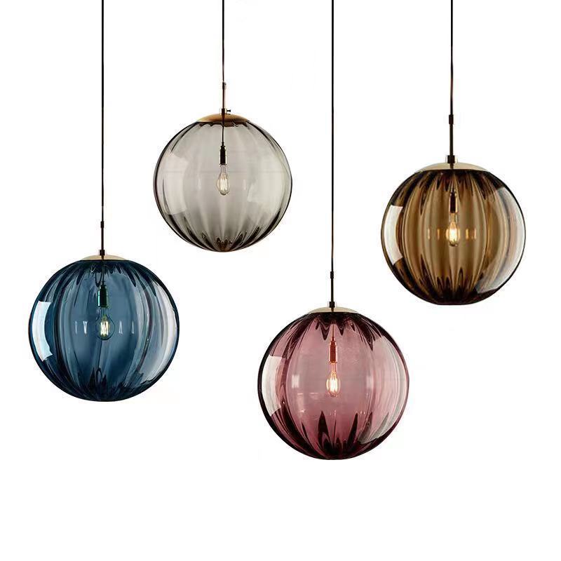 Clear glass ball pendant lamp by DEMOLIGHTS hanging from ceiling, stylish modern pendant light for contemporary interiors
