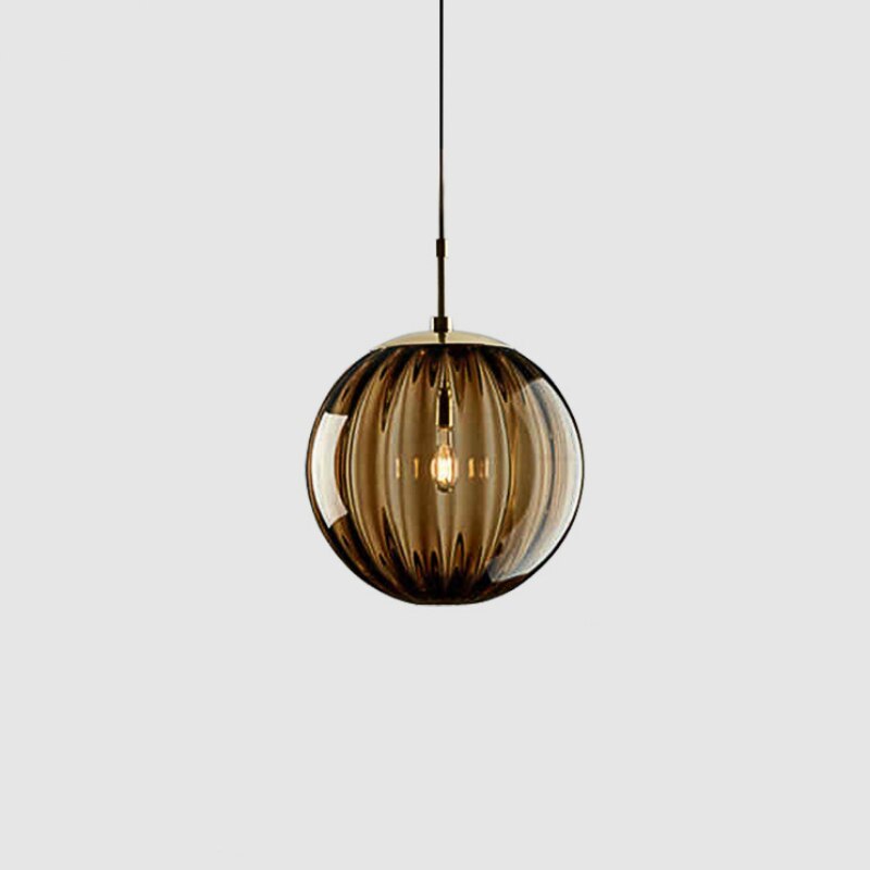 Clear glass ball pendant lamp by DEMOLIGHTS hanging from ceiling, showcasing modern pendant light design.