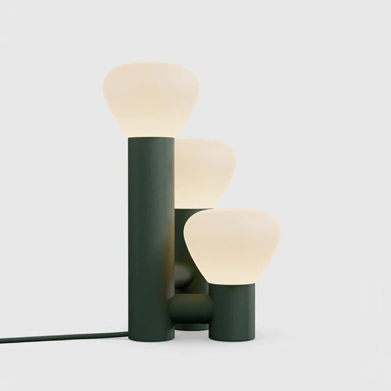 Minimalist DEMOLIGHTS 3-light table lamp with red, green, and white shades on a sleek base, ideal for modern home decor.