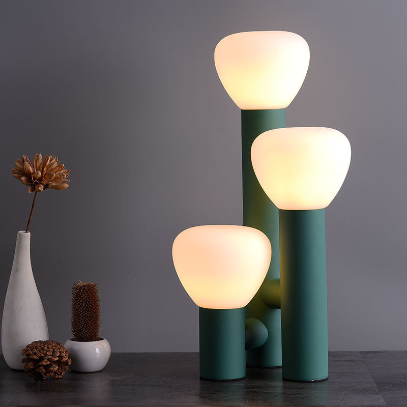 Minimalist 3-light table lamp by DEMOLIGHTS with red, green, and white shades, modern design for stylish lighting.
