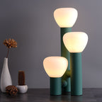 Minimalist 3-light table lamp by DEMOLIGHTS with red, green, and white shades, modern design for stylish lighting.