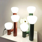 Demolights minimalist 3-light table lamp with red, green, and white shades, modern design for stylish home lighting.