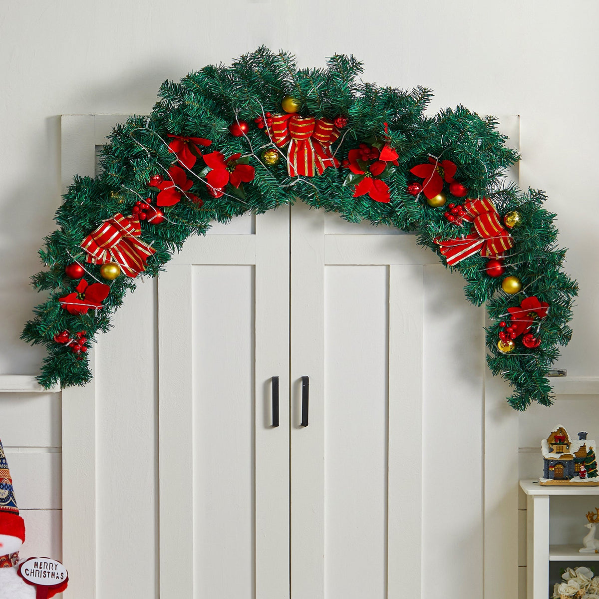 Artificial 180cm Christmas swag by Garden Sanctuary, decorated with pine, berries, and ornaments for front door decor.