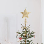 Golden glitter Christmas tree star topper with intricate design, perfect for holiday decorations and home Christmas celebrations.
