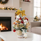 Garden Sanctuary tabletop Christmas tree with LED lights, featuring lush green foliage and festive holiday decorations.