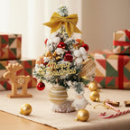 Garden Sanctuary tabletop Christmas tree with LED lights, decorated with festive ornaments and green foliage.