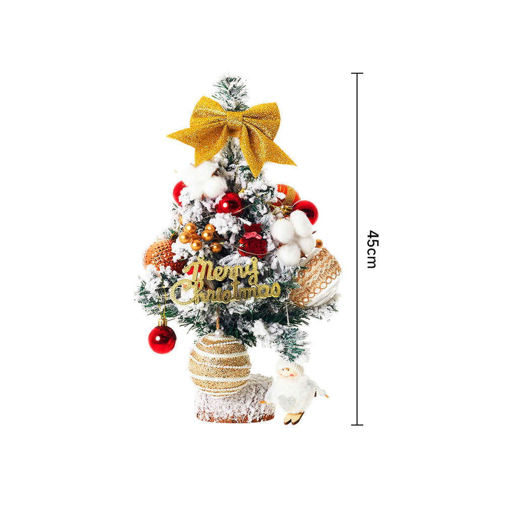 Small tabletop Christmas tree with LED lights from Garden Sanctuary, decorated with ornaments and pine branches for festive decor.