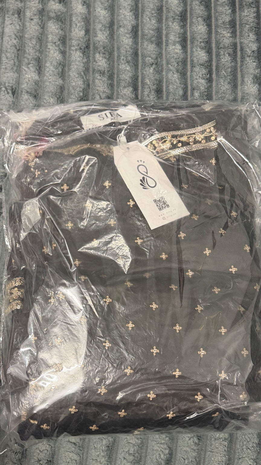 Black kurta with gold-tone embroidery and decorative neckline, tag attached