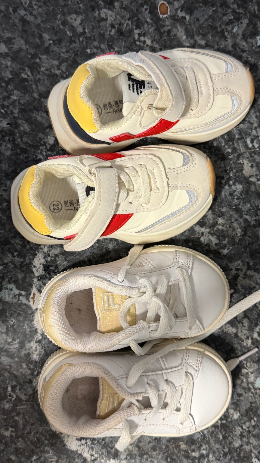 Two pairs of pre-owned children's trainers in cream and white with colourful and gold-tone accents